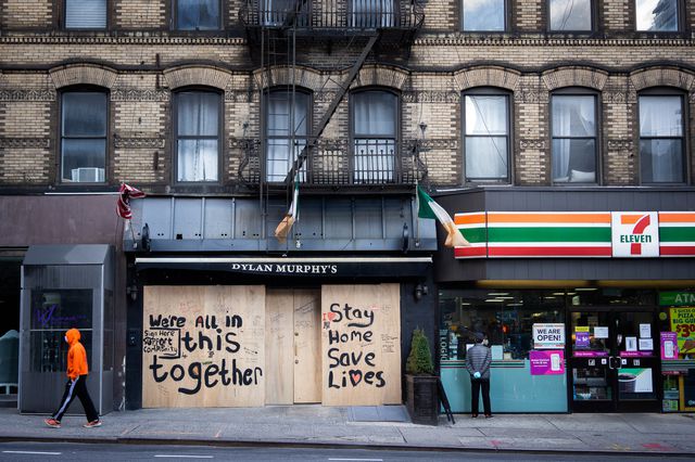 A photo of shuttered stores on Third Avenue with signs saying "we're all in this together"